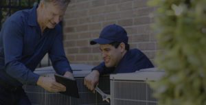 two professionals are checking the air conditioner