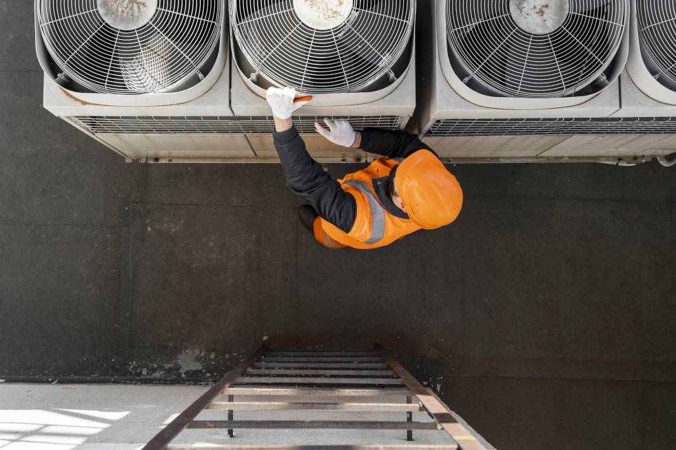 Ariel view of the professional checking the air conditioner 