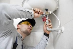 a technician is repairing the heating system