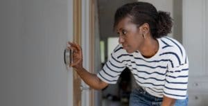 a young girl is setting the temperature of the appliance