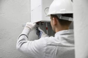 a technician is repairing the heating system